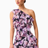 Woman wearing a Solene purple floral one-shoulder dress on a white background