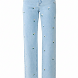 Light blue denim jeans with small embroidered white flowers and green stems scattered across the front, shown on a plain white background.