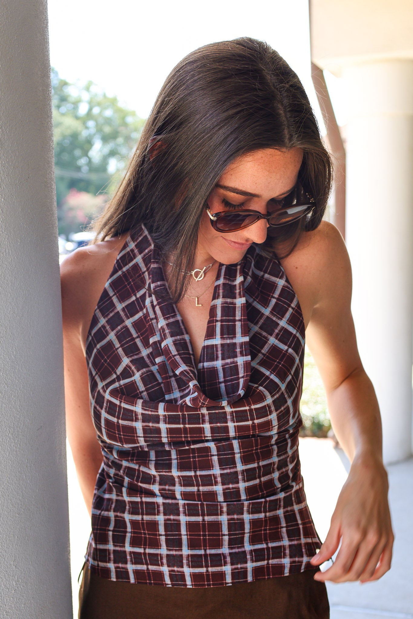 Brown and light blue plaid draped halter top, styled with brown z supply Palermo Sunglasses at Rodeo Boutique.