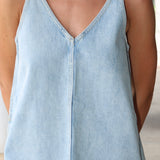 Woman wearing a light denim Tavi dress by Pistola.