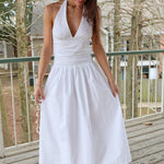 Woman wearing a white midi dress with plunging v neck
