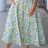 Person wearing a floral dress with a blurred background