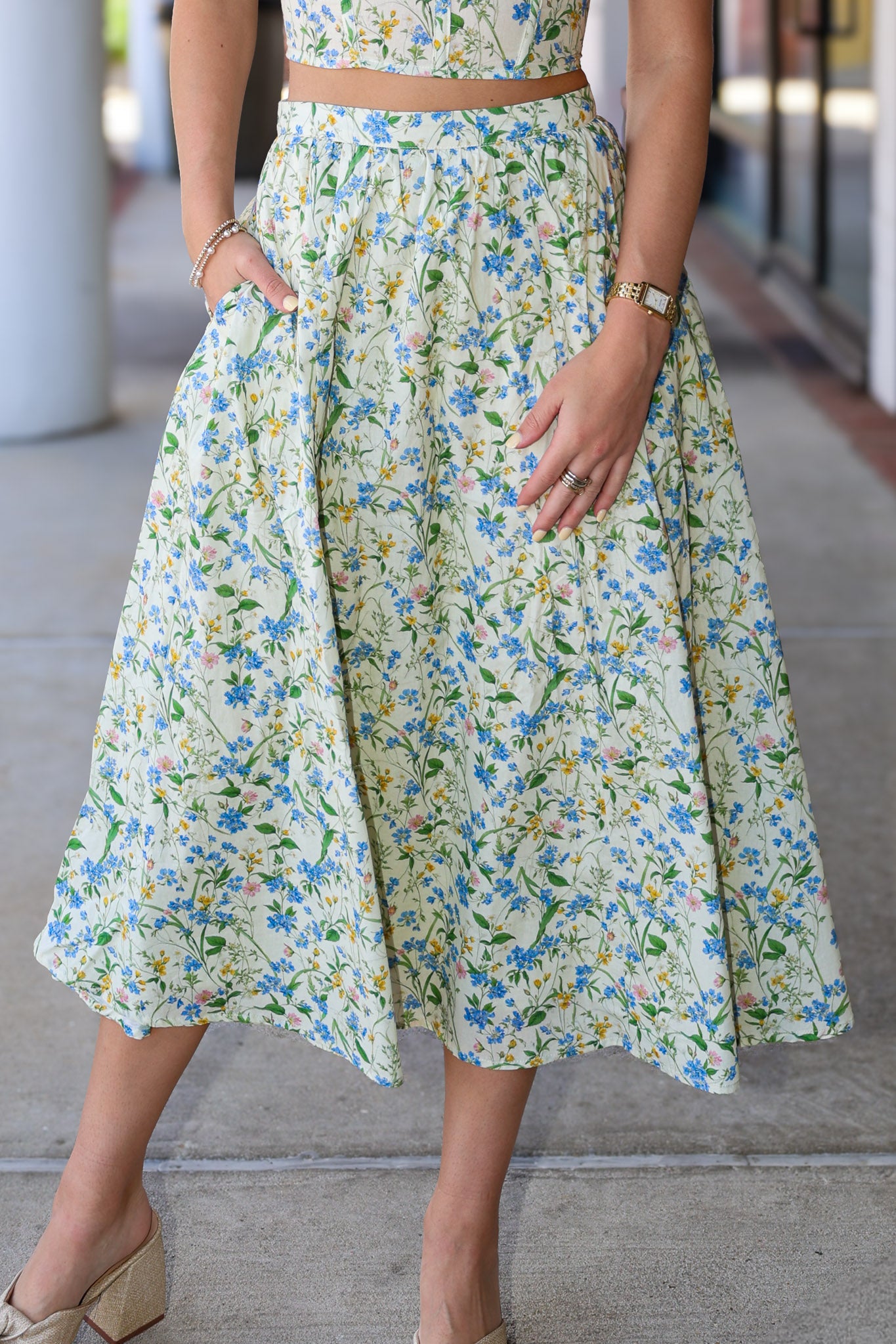 Person wearing a floral dress with a blurred background